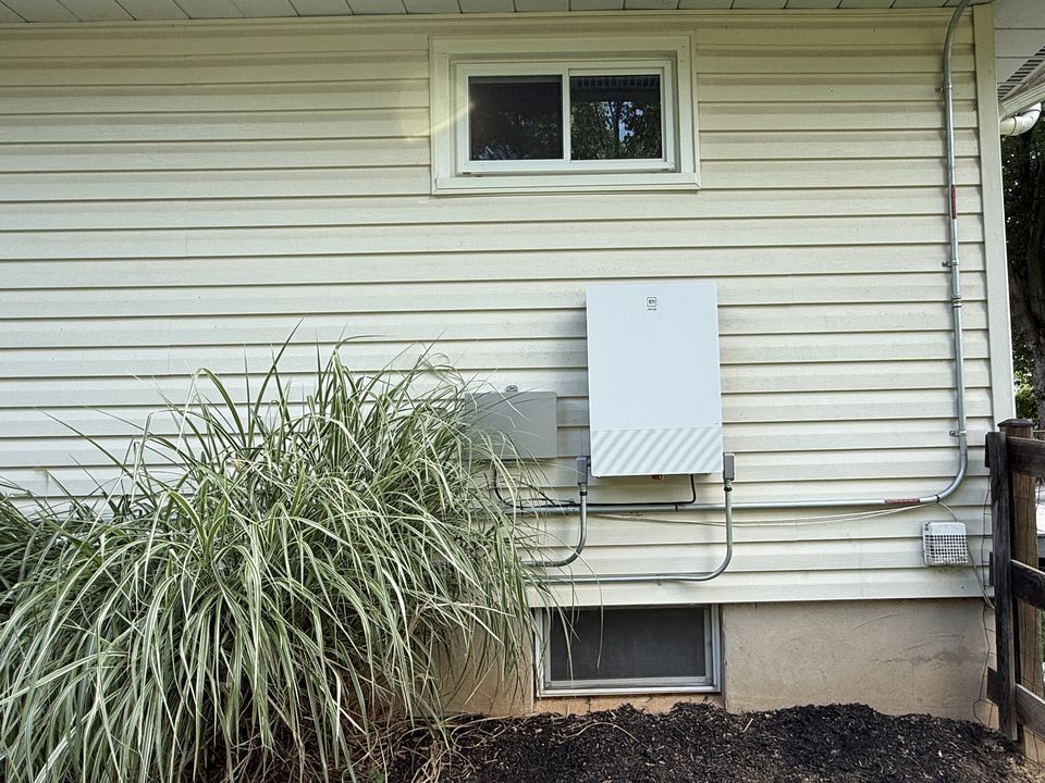 GM Energy V2H equipment mounted on the exterior of a residence