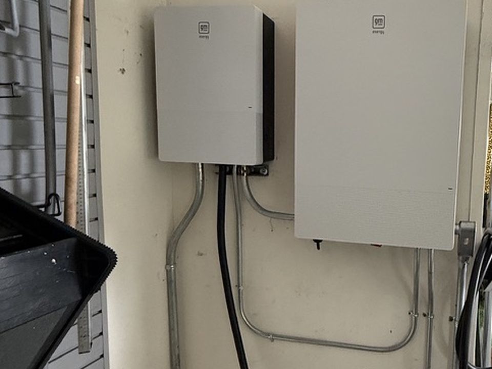 GM Energy V2H equipment and charging cable installed in a residential garage